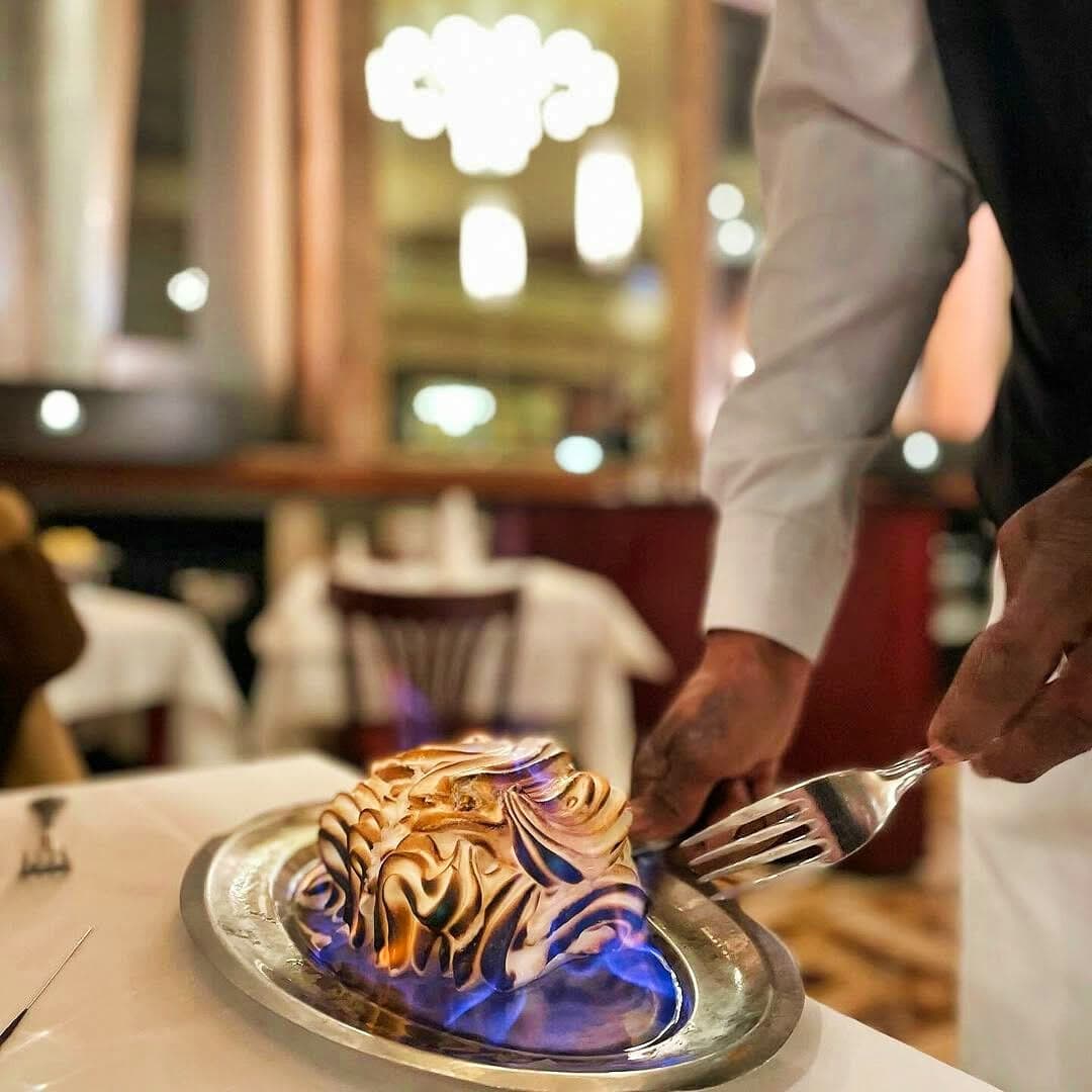 Omelette norvégienne flambée au guéridon dans la grande salle Art Déco