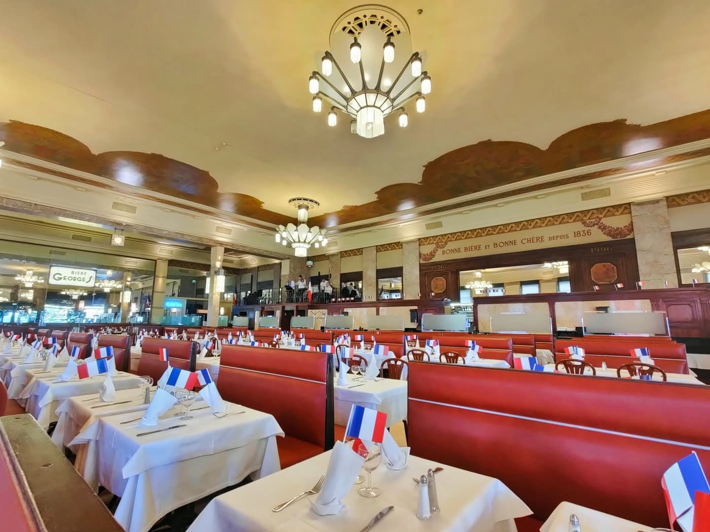 Salle décorée de petits drapeaux français sur les tables, vue panoramique — Brasserie Georges