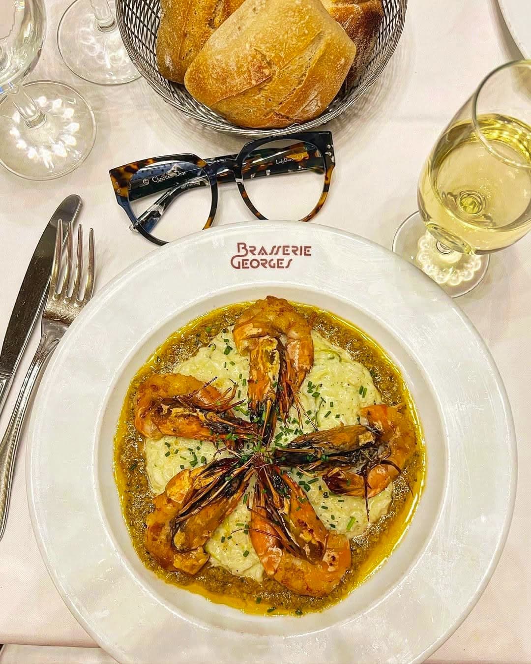Langoustines rôties disposées en étoile sur crème, vue de dessus avec pain — Brasserie Georges